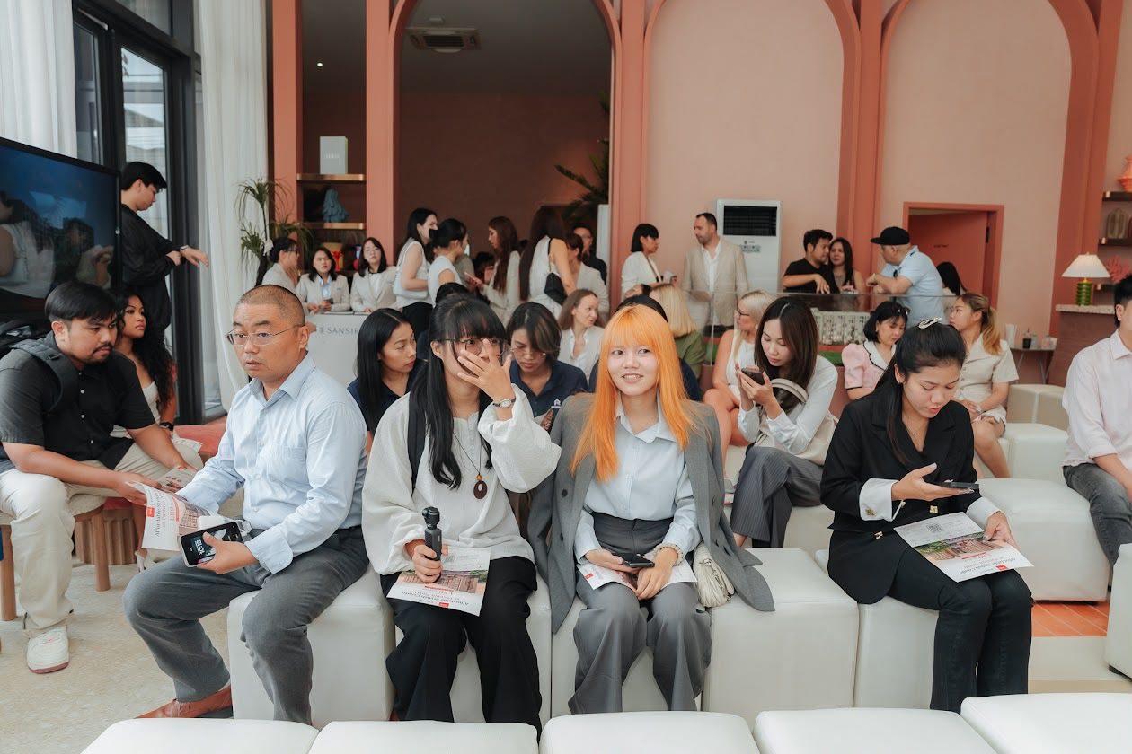 Clients and colleagues seated at a developer presentation